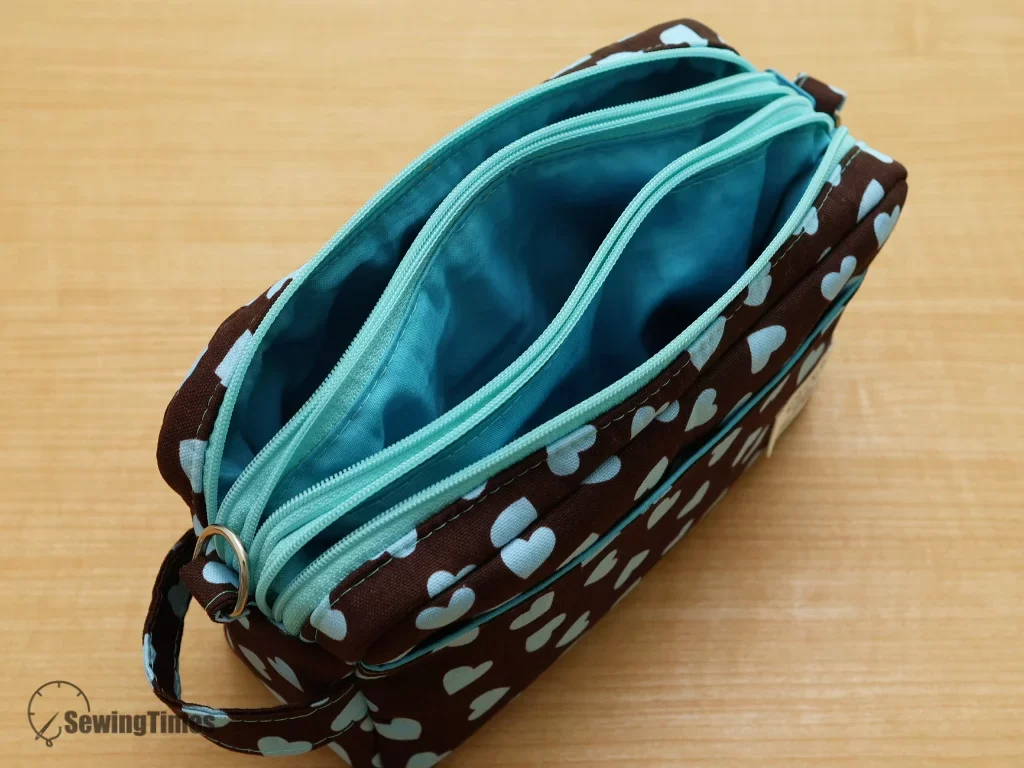 A top-down view showing the three separate internal compartments and blue lining of the bag for ultimate organization.