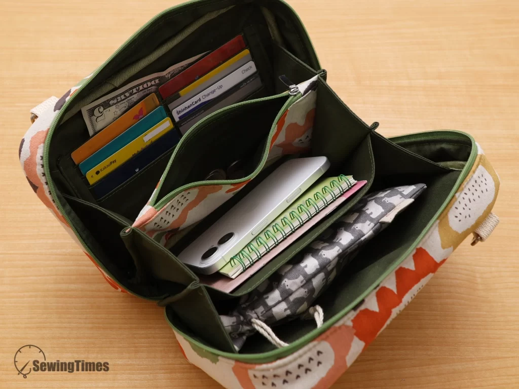Inside view of the multi-functional travel wallet purse showing the center zippered divider pocket, card slots, and deep storage compartments.