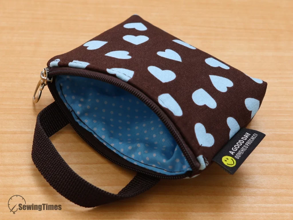 Interior view of a DIY mini pouch showing blue polka dot lining and zipper detail