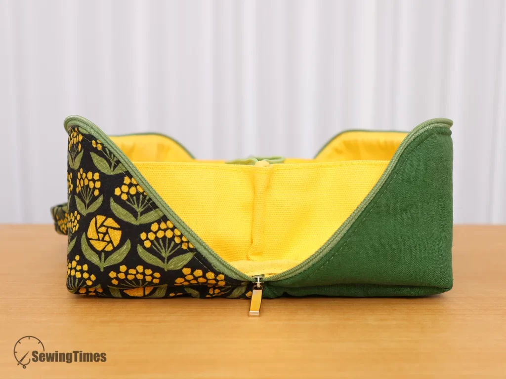Side view of a wide-opening fabric organizer showing its unique structure that allows the bag to open completely flat.