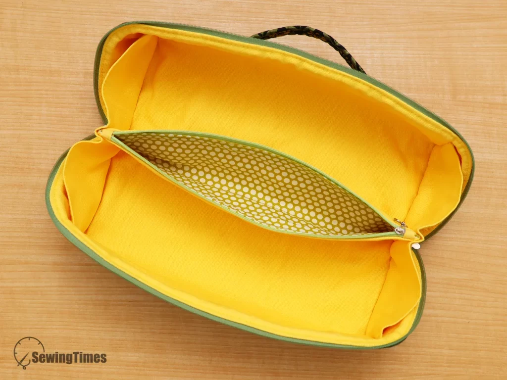 Top-down view of an empty handmade travel bag featuring a clever center zipper pocket and wide storage space.