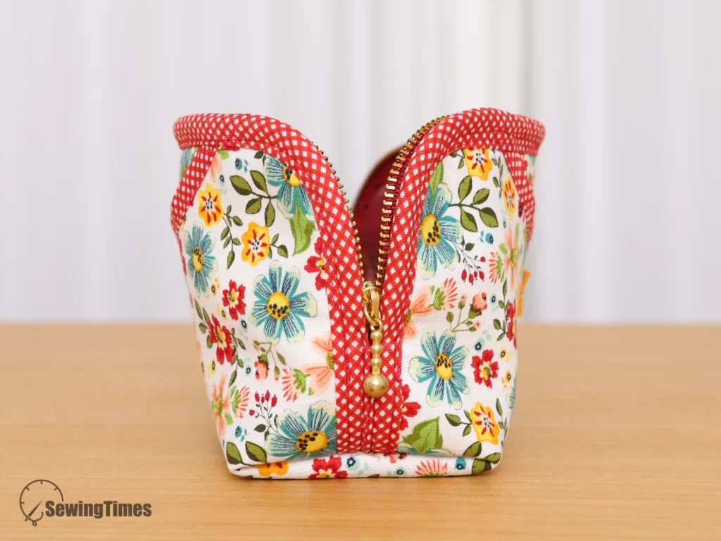 Side view of the pencil case showing how the metal zipper extends all the way down to the bottom, allowing the pouch to open wide.