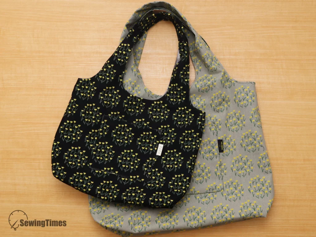 Medium and large sizes of the handmade fabric shoulder bags overlapping on a wooden background.