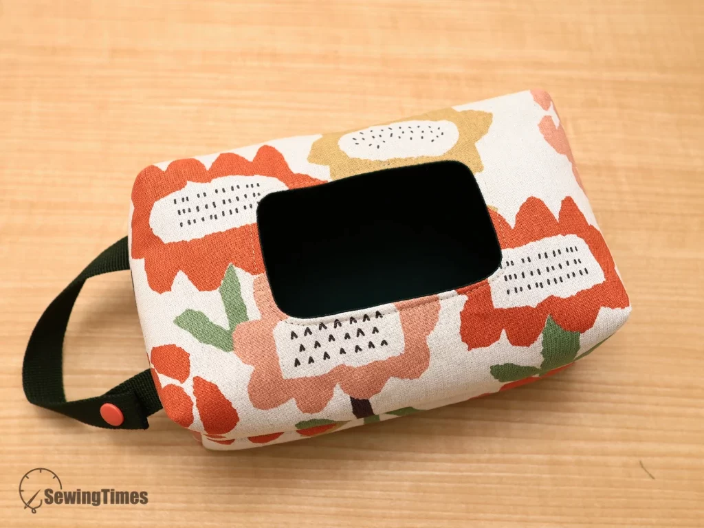 Handmade wipes pouch showing the rectangular front opening for plastic flip-top caps.