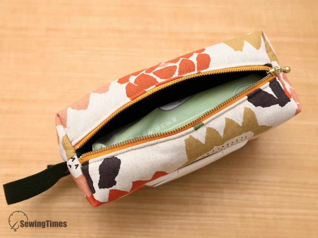 Top zipper opening of the baby wipes pouch revealing a standard wipe pack inside.